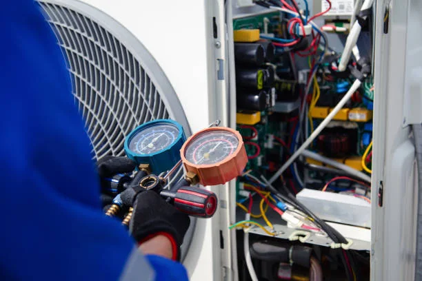 HVAC service gauges connected during a cooling-system inspection